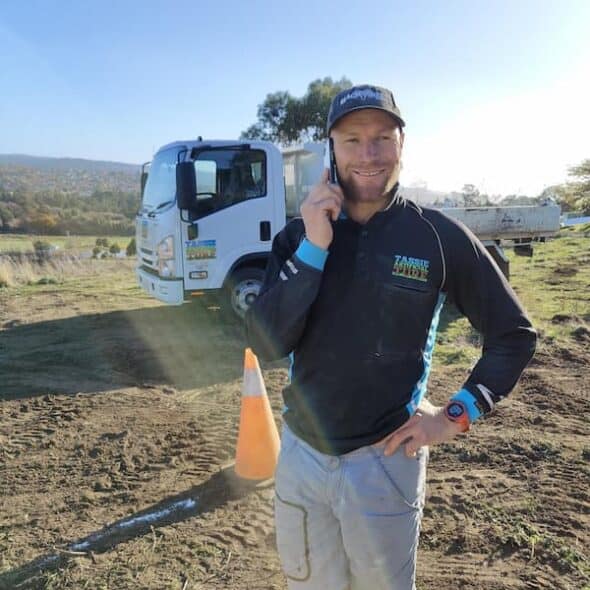 Photo of Jade talking on mobile phone at a landscaping project site.